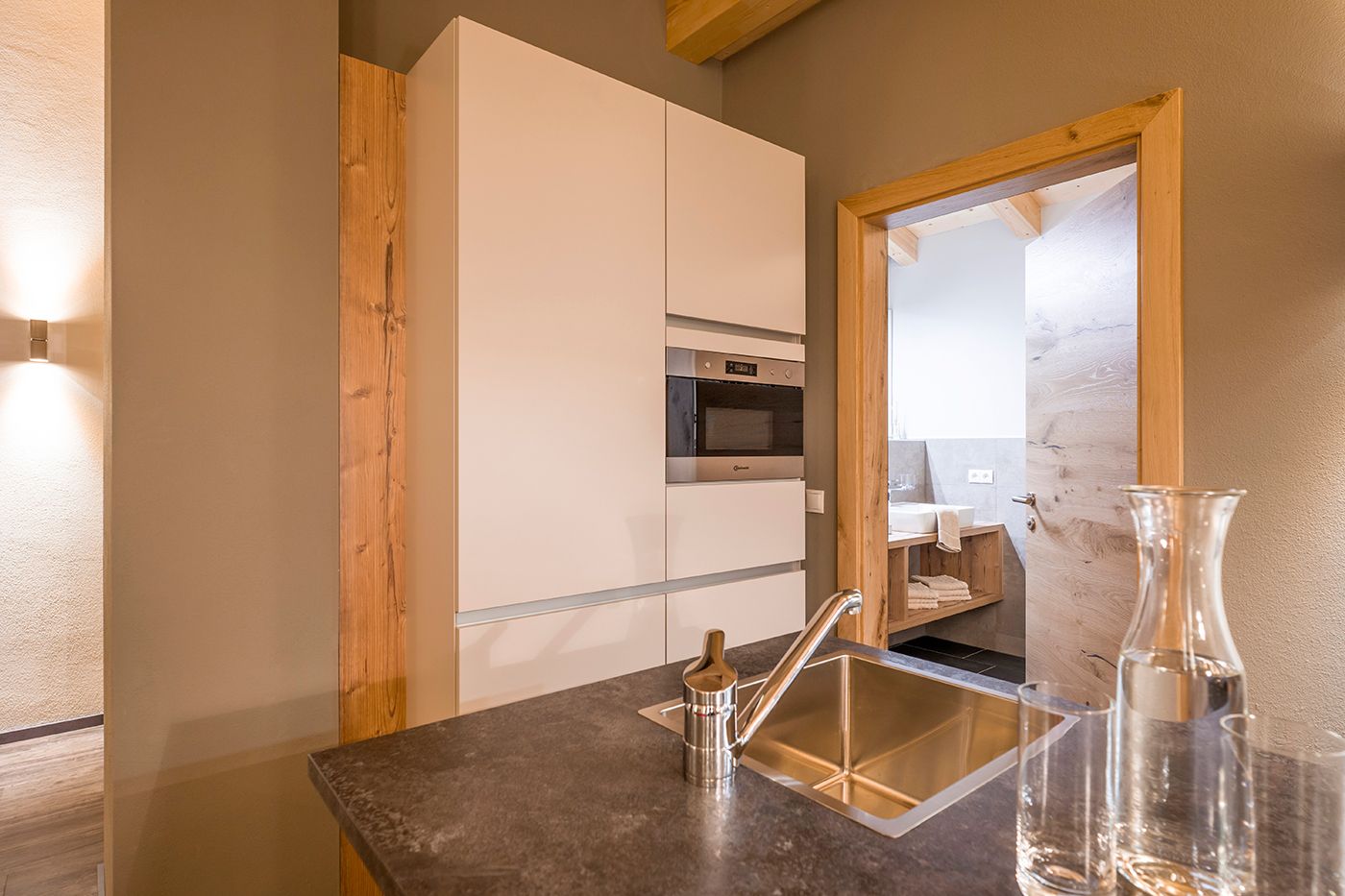 Kitchen area with sink and integrated microwave in the cabinets