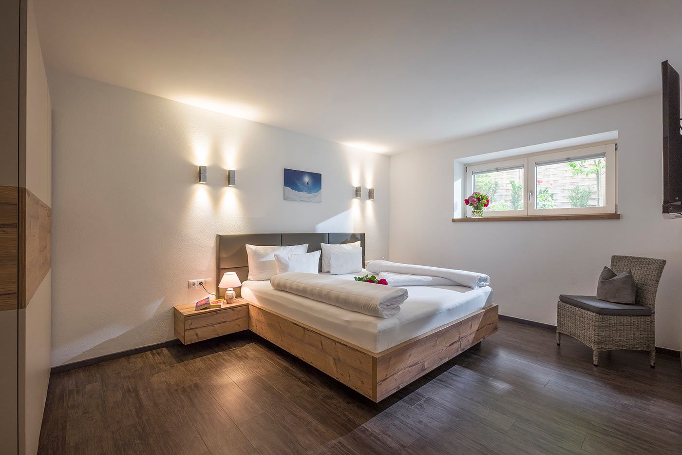 A photo of the apartment bedroom with a double bed and a window