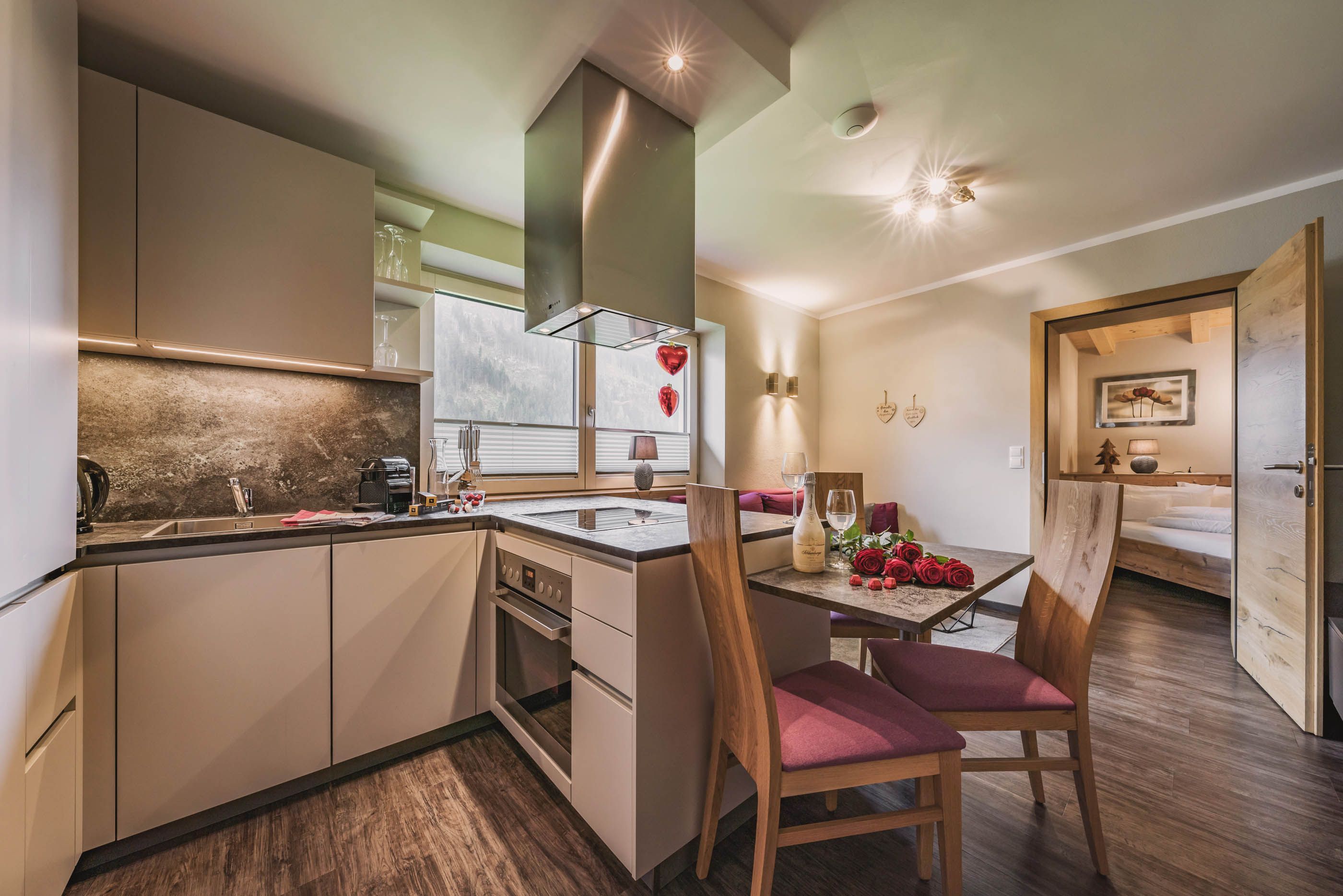 Elegant L-shaped kitchen with dining area and romantic decoration