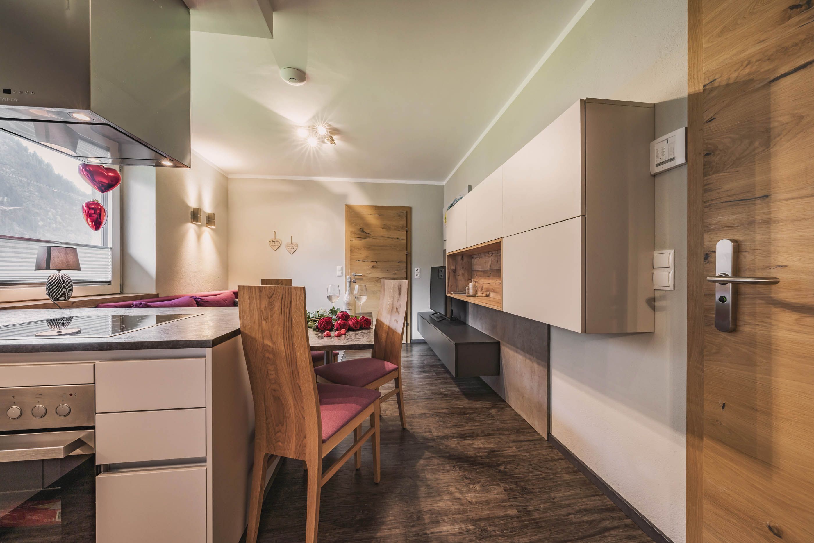 Modern kitchen counter with white high-gloss fronts, kitchen island and extractor hood