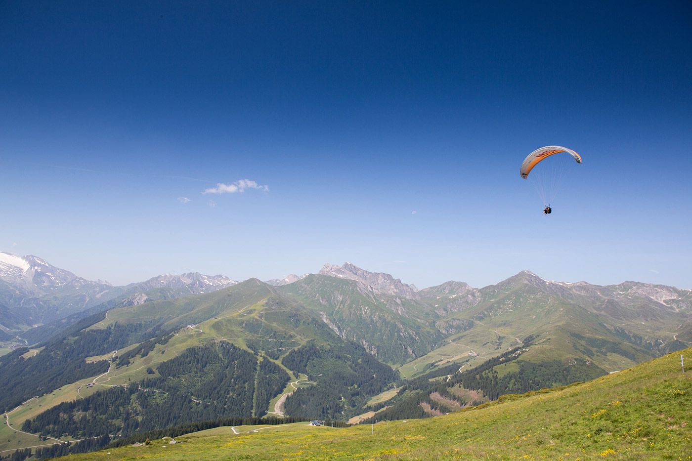 Paraglider in the air over the Zillertal with mountain panorama